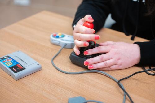 A hand on a video game joystick. 