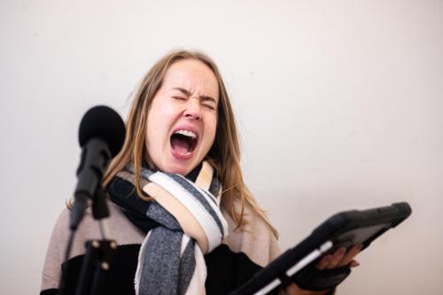 Helen Mackay in rehearsals, screaming into a microphone.